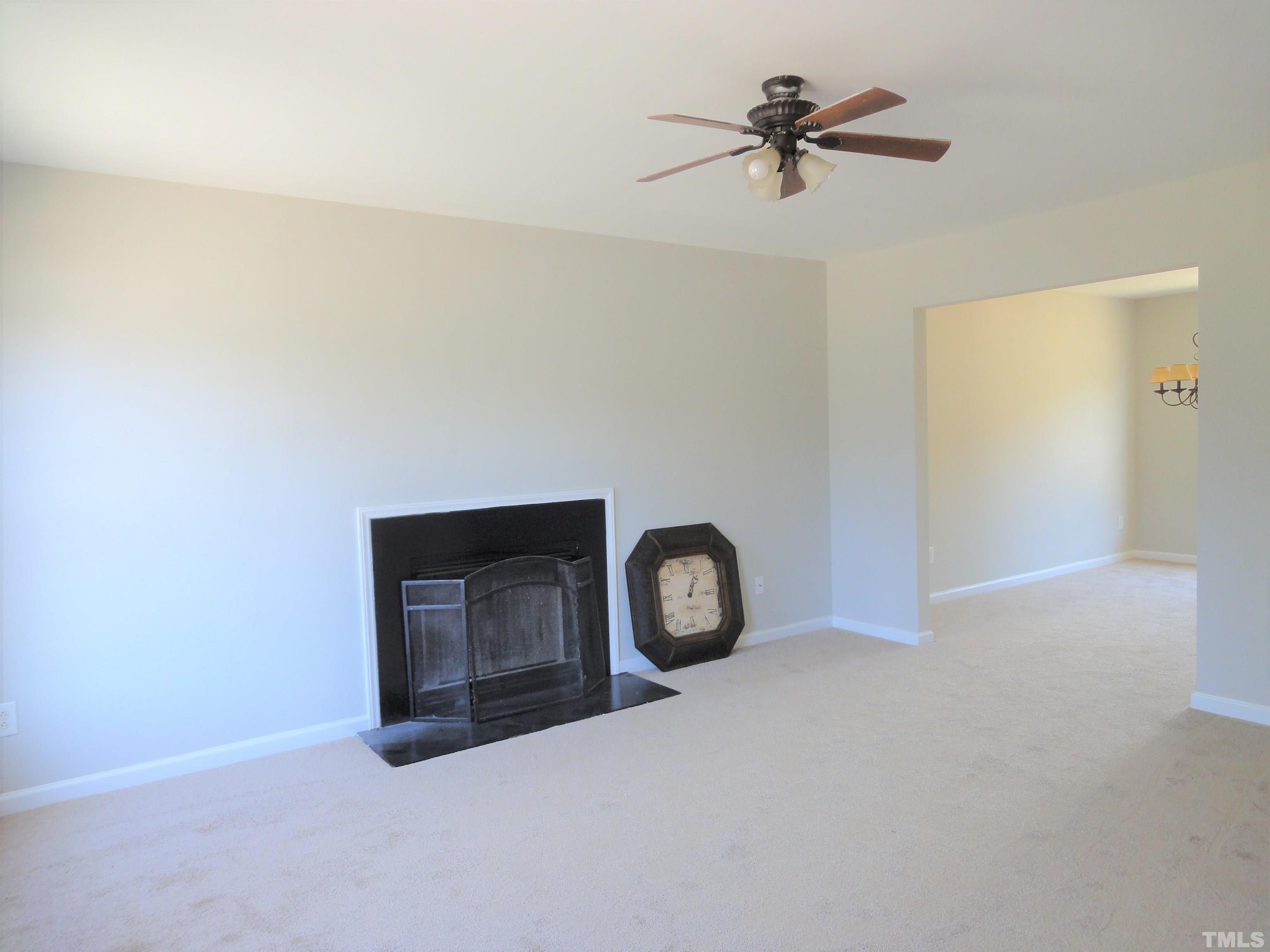 3615 Cyrus Street Raleigh, NC 27610 - Photo 6 of 36 a view of a livingroom with a ceiling fan and a chandelier fan