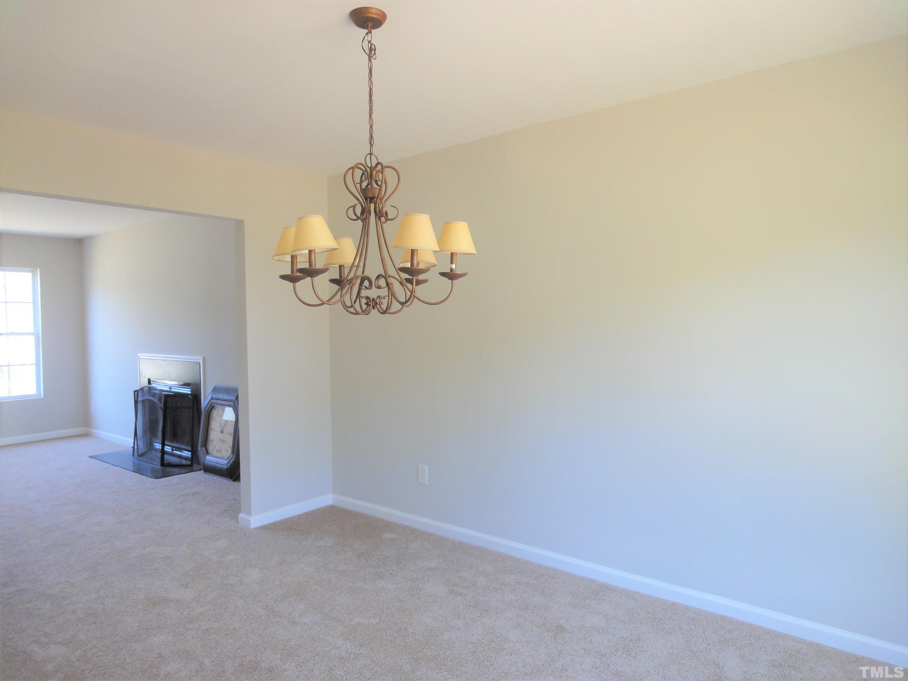 3615 Cyrus Street Raleigh, NC 27610 - Photo 10 of 36 a view of a room with a hanging light and kitchen