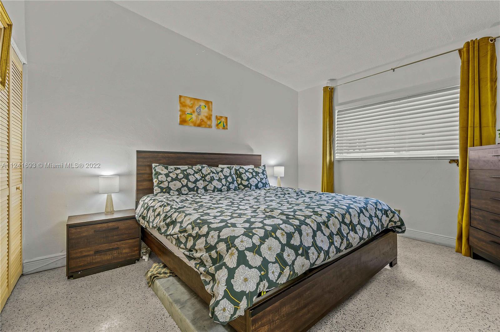 6730 Southwest 32nd Street Miami, FL 33155 - Photo 16 of 31 a large bed sitting in a bedroom next to a window