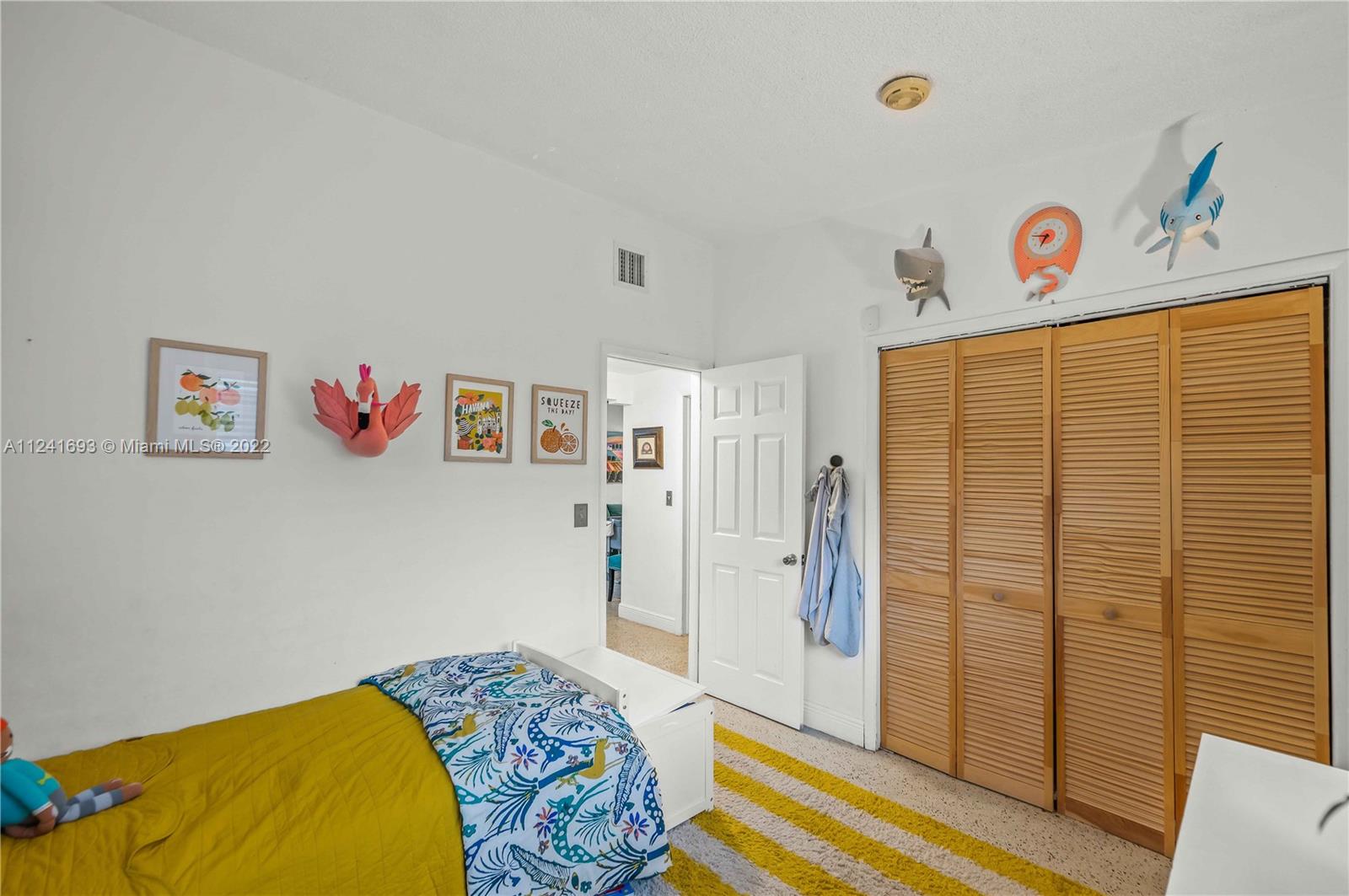 6730 Southwest 32nd Street Miami, FL 33155 - Photo 20 of 31 a bedroom with a bed and a dresser