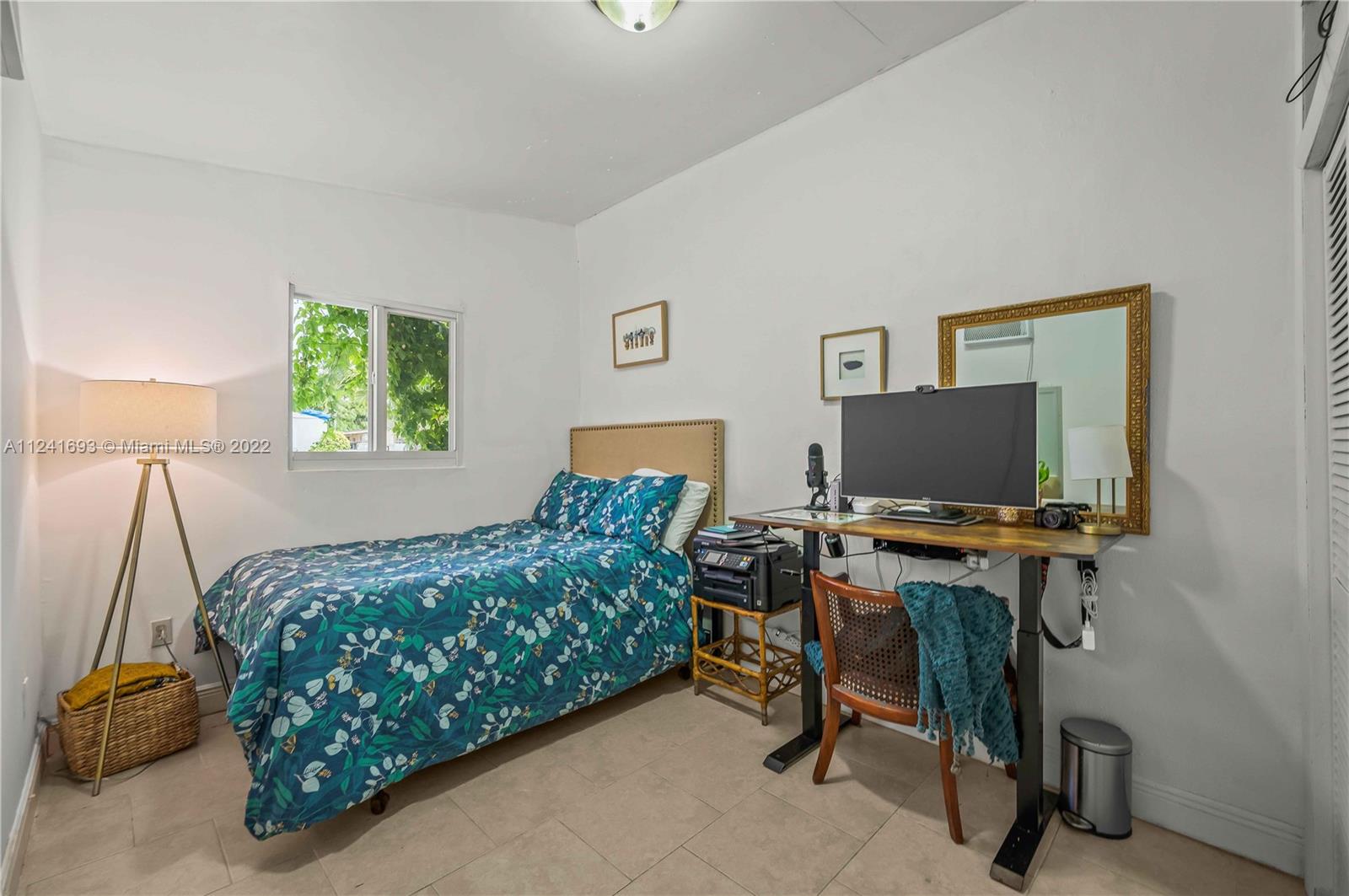 6730 Southwest 32nd Street Miami, FL 33155 - Photo 23 of 31 a bedroom with a bed and a desk