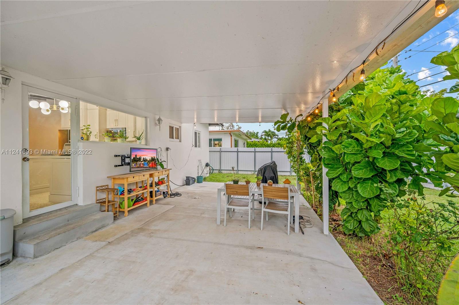 6730 Southwest 32nd Street Miami, FL 33155 - Photo 30 of 31 a backyard of a house with table and chairs