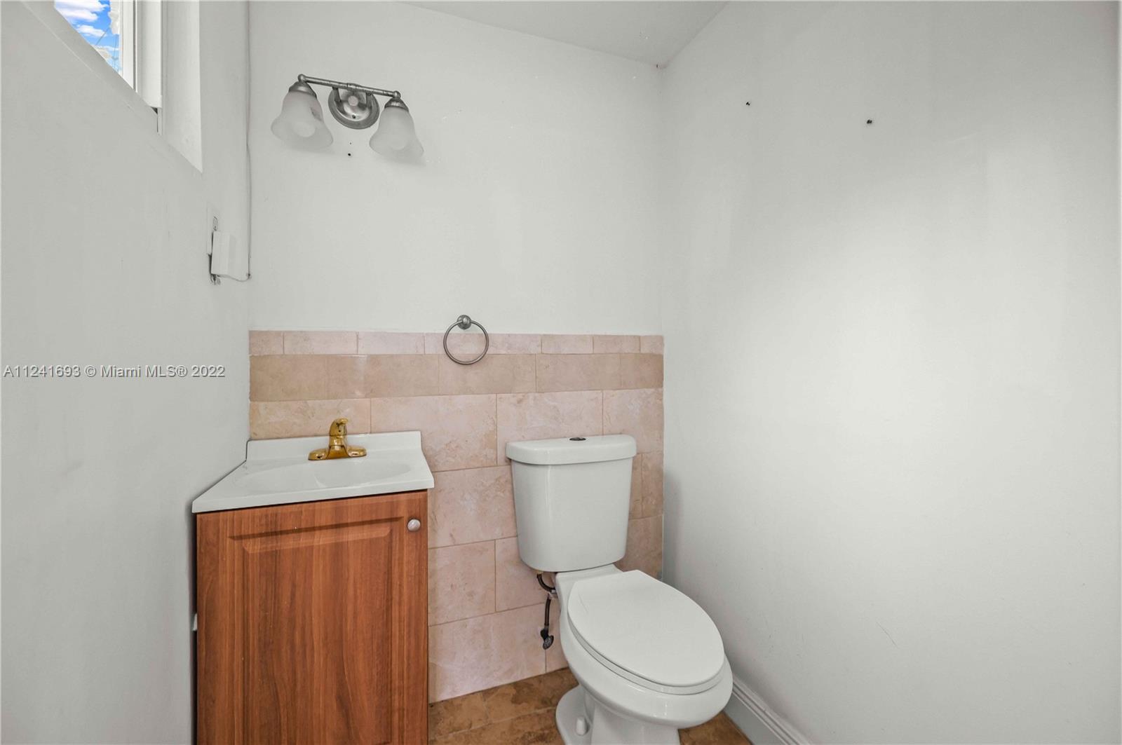 6730 Southwest 32nd Street Miami, FL 33155 - Photo 31 of 31 a white toilet sitting next to a bathroom sink