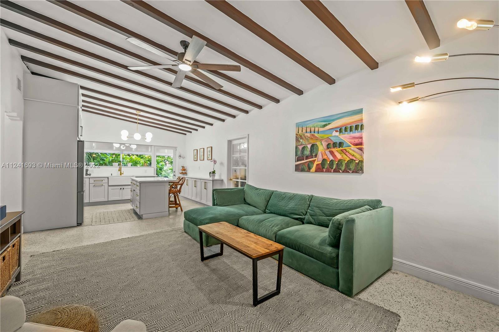 6730 Southwest 32nd Street Miami, FL 33155 - Photo 7 of 31 a living room with furniture a floor to ceiling window and a flat screen tv