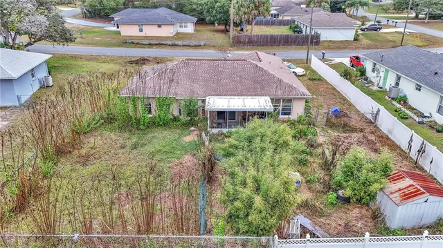 an aerial view of a house with yard swimming pool and outdoor seating