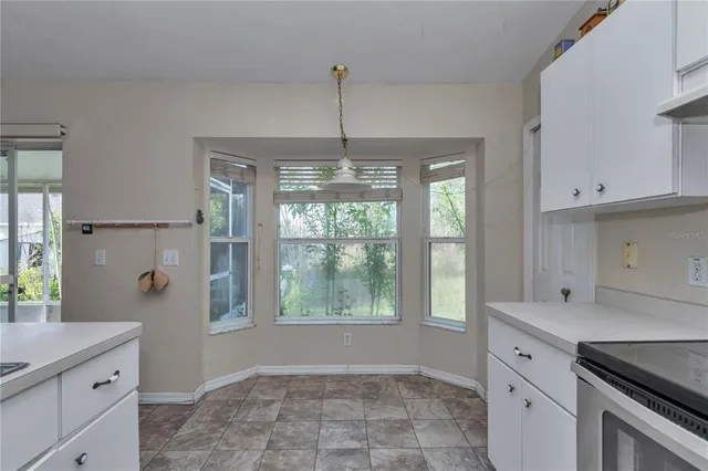 a kitchen with a refrigerator and window
