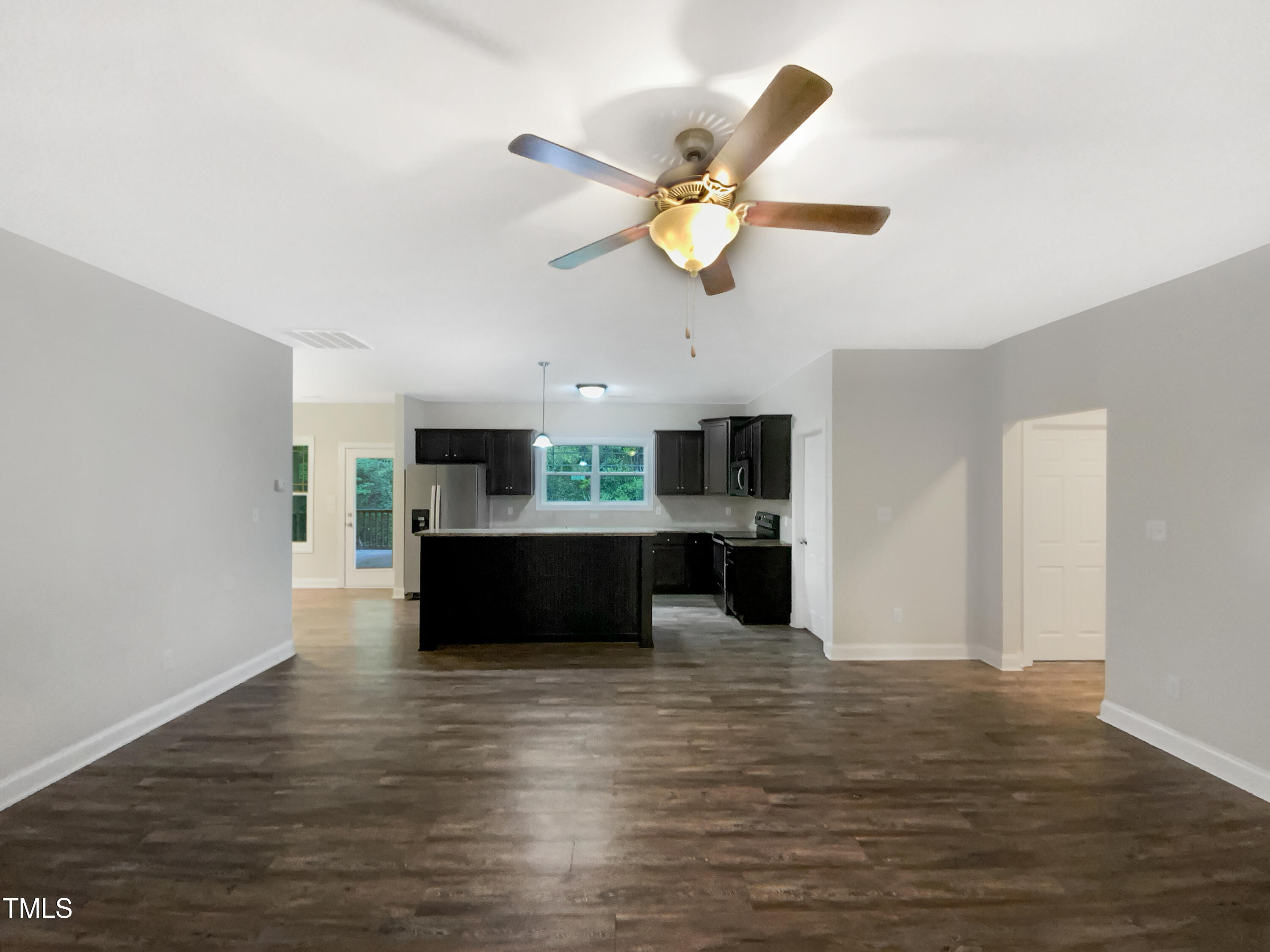 85 Landlocked Circle Angier, NC 27501 - Photo 12 of 21 a view of a living room and kitchen with wooden floor