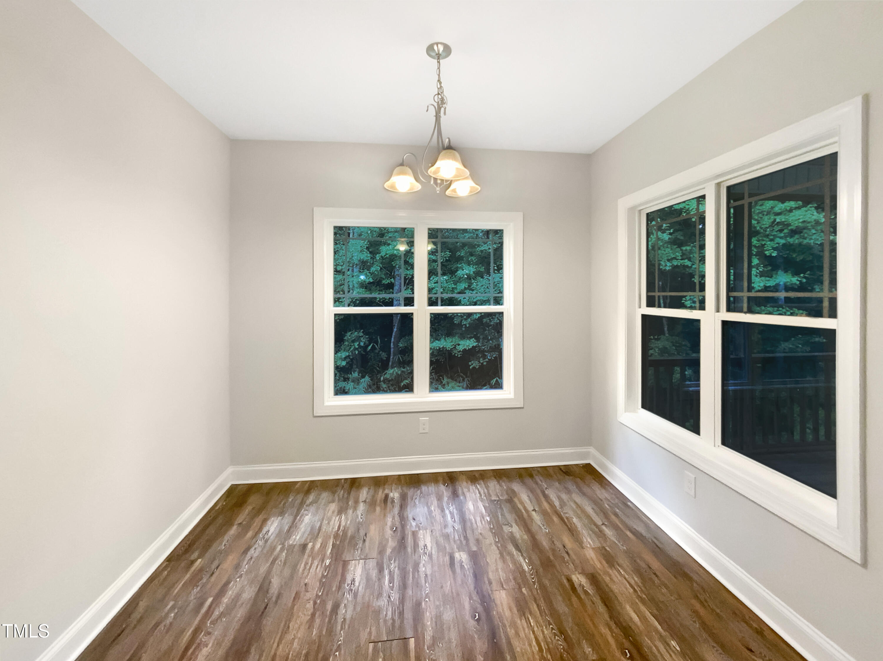 85 Landlocked Circle Angier, NC 27501 - Photo 13 of 21 an empty room with wooden floor exposed radiator and windows