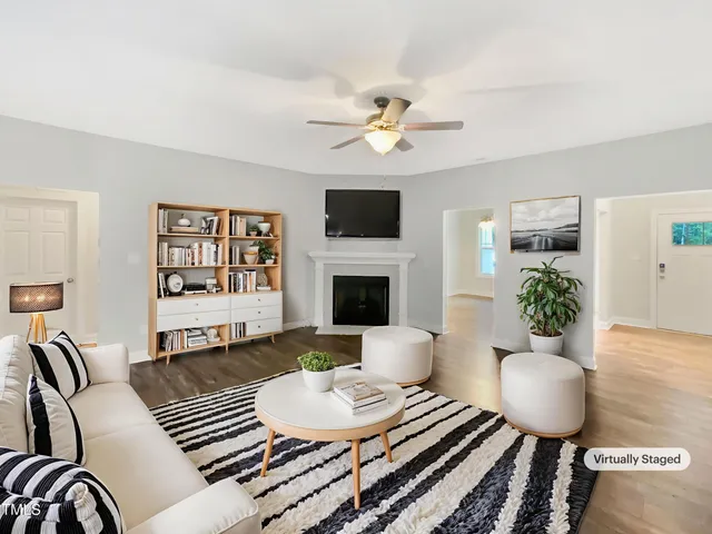 a living room with furniture a fireplace and a flat screen tv