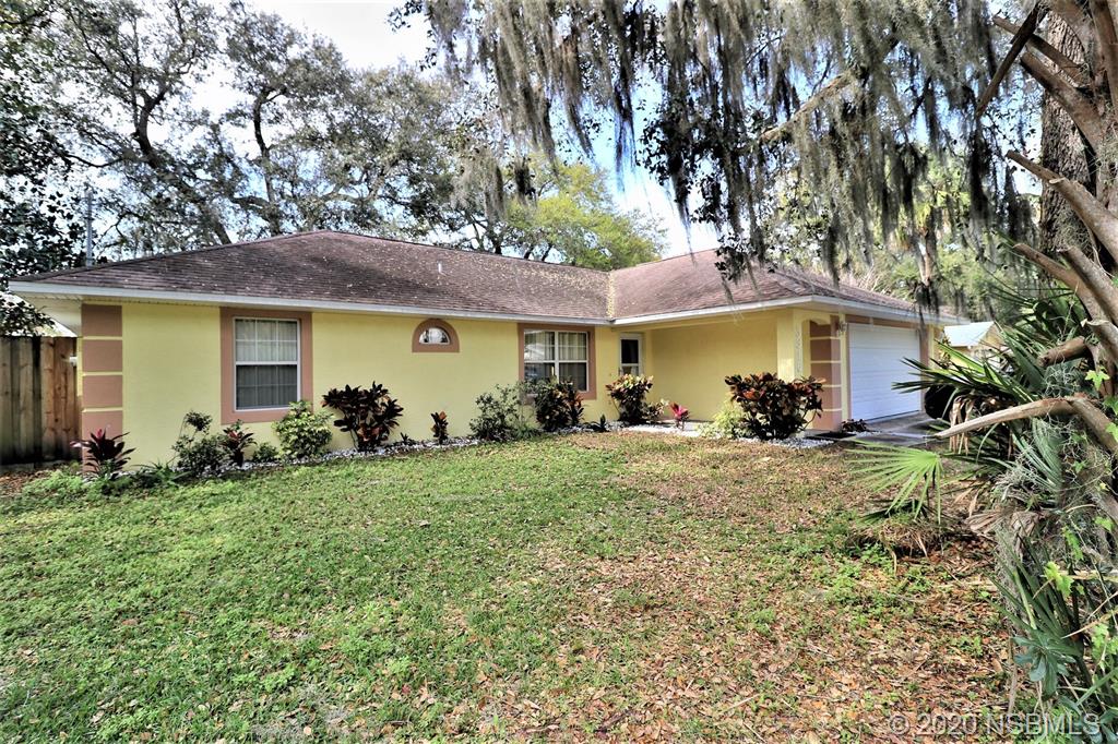 a view of a house with garden and yard