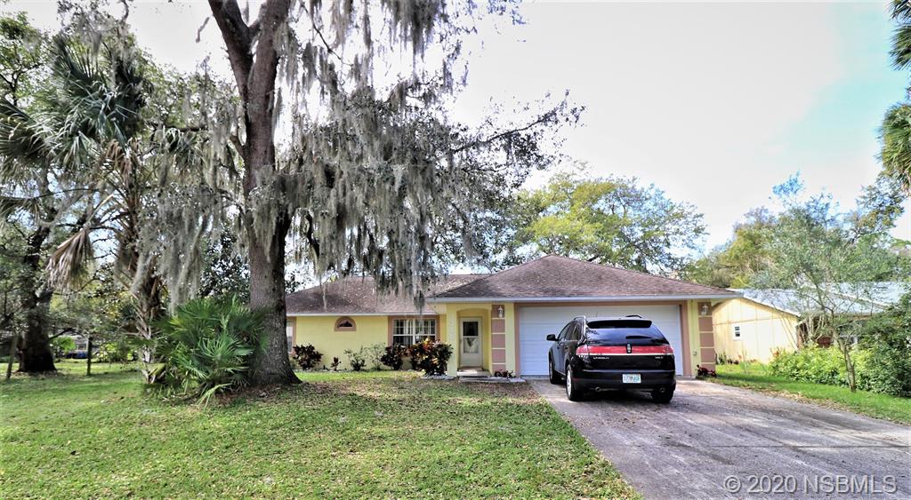 3316 Mango Tree Drive Edgewater, FL 32141 - Photo 2 of 28 a car parked in front of a house with a yard
