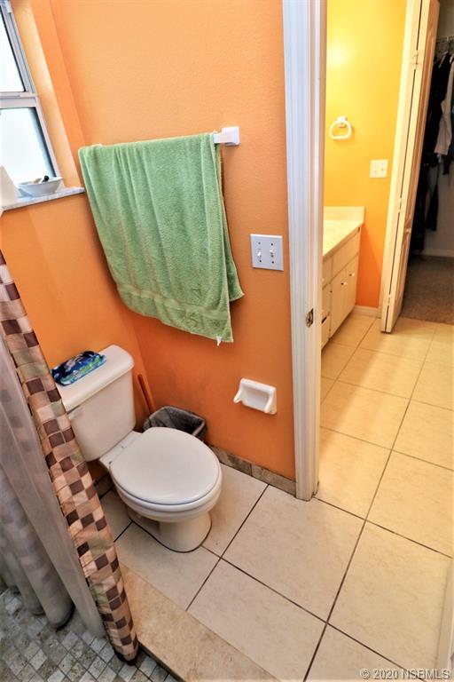 3316 Mango Tree Drive Edgewater, FL 32141 - Photo 16 of 28 a bathroom with a toilet and a mirror