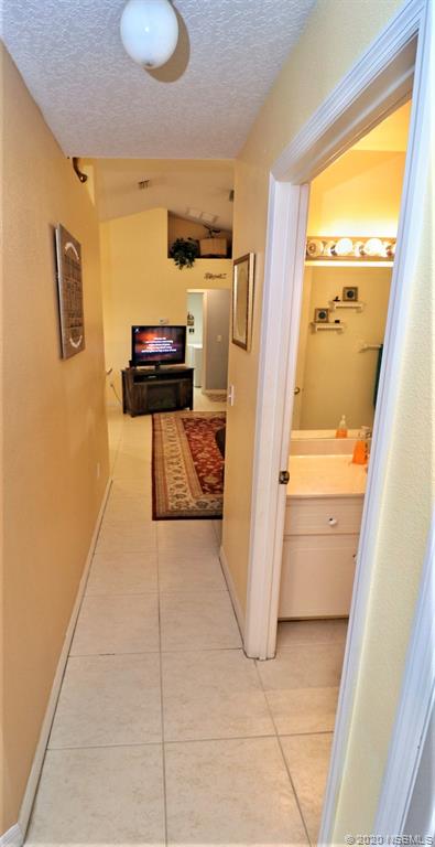 3316 Mango Tree Drive Edgewater, FL 32141 - Photo 19 of 28 a hallway with storage and utility
