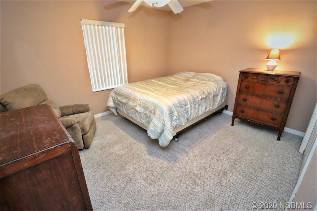 3316 Mango Tree Drive Edgewater, FL 32141 - Photo 20 of 28 a bedroom with a bed and furniture
