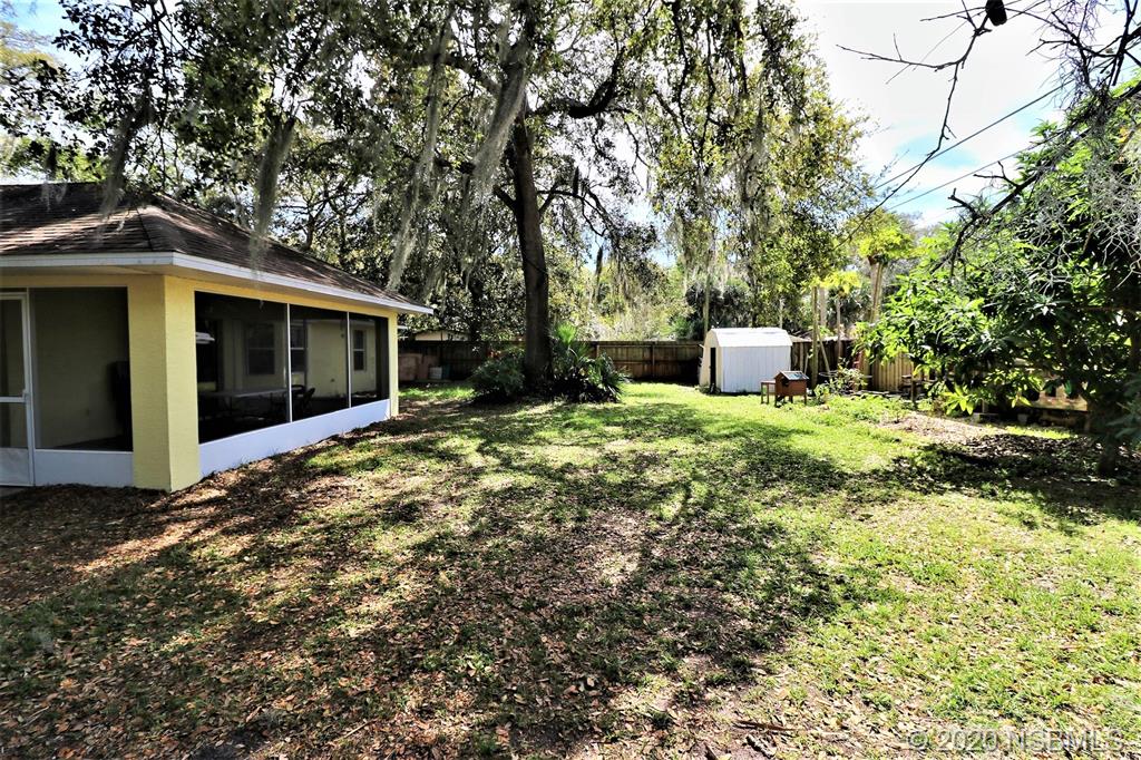 3316 Mango Tree Drive Edgewater, FL 32141 - Photo 24 of 28 a view of a house with a yard