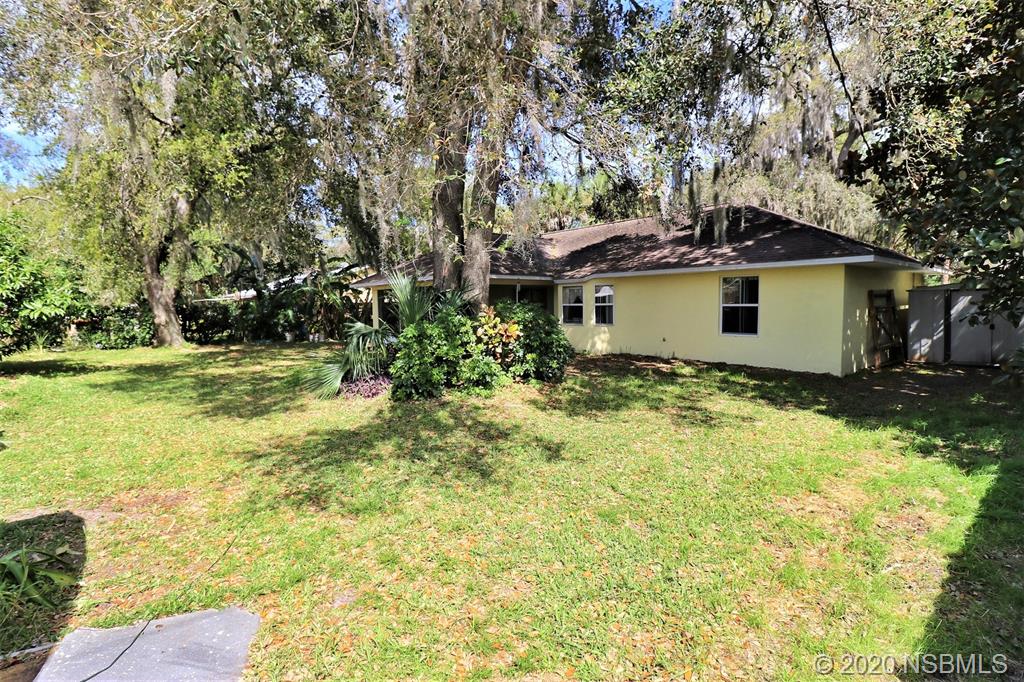 3316 Mango Tree Drive Edgewater, FL 32141 - Photo 25 of 28 a house with trees in front of it