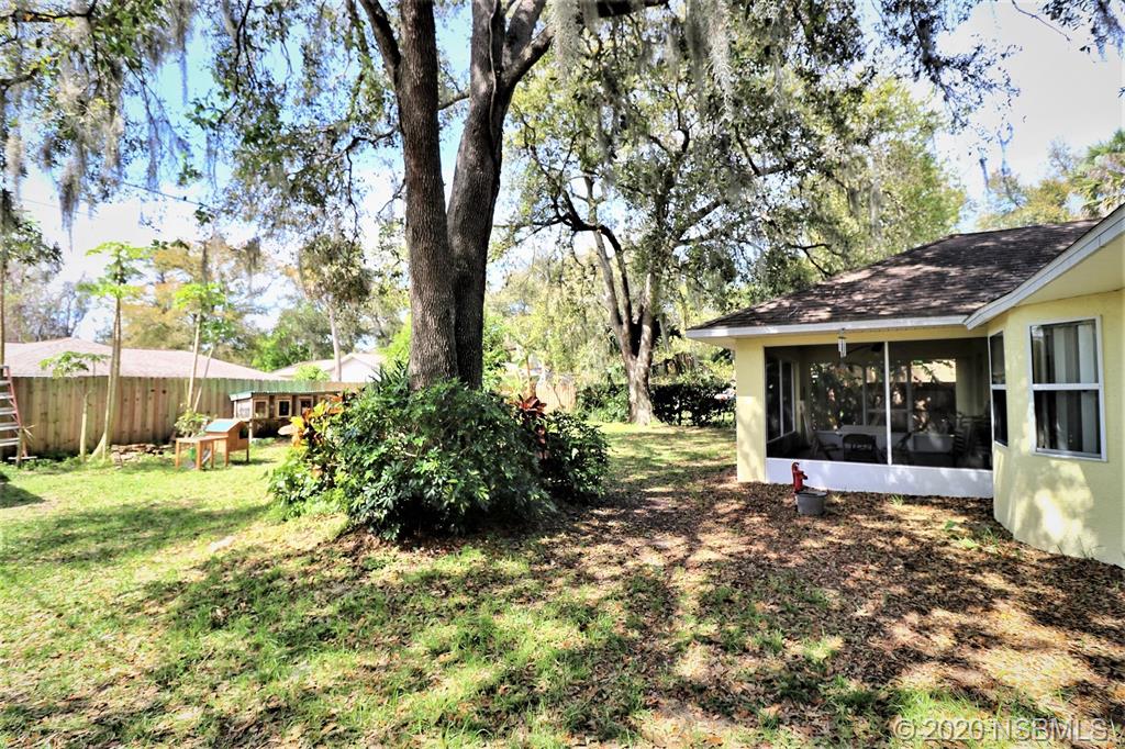 3316 Mango Tree Drive Edgewater, FL 32141 - Photo 26 of 28 a front view of a house with a garden