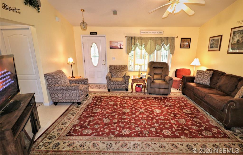 3316 Mango Tree Drive Edgewater, FL 32141 - Photo 6 of 28 a living room with furniture rug and wooden floor