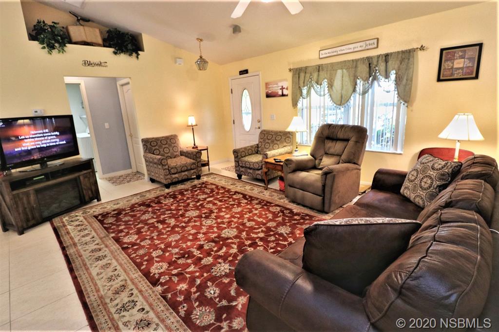 3316 Mango Tree Drive Edgewater, FL 32141 - Photo 7 of 28 a living room with furniture and a couch