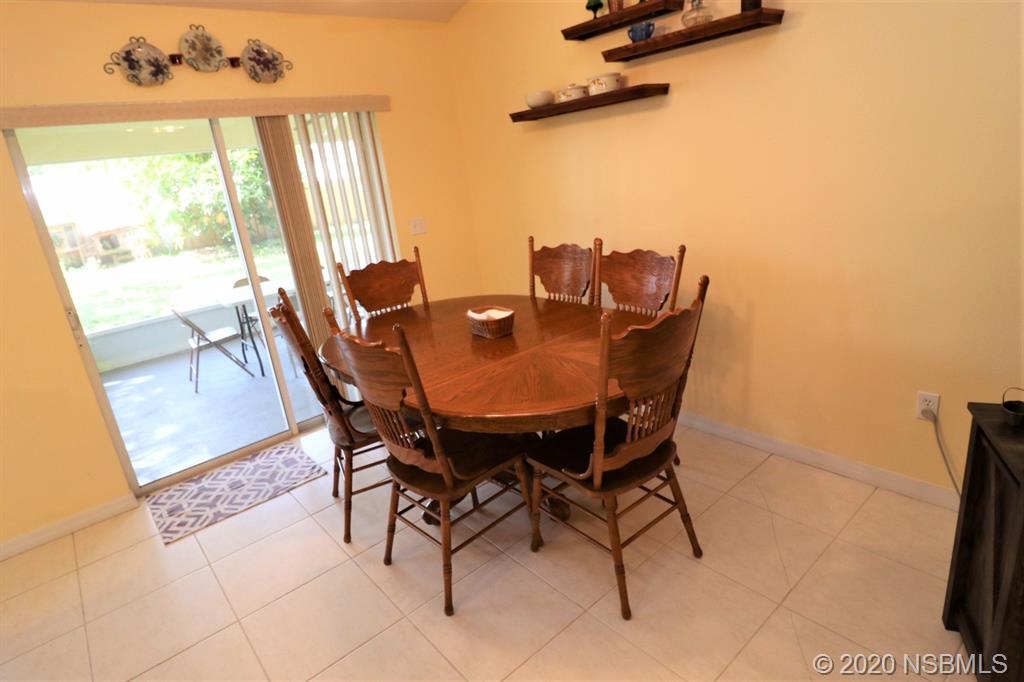 3316 Mango Tree Drive Edgewater, FL 32141 - Photo 9 of 28 a dining room with furniture and wooden floor