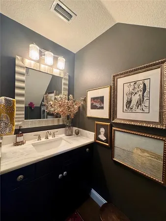 a bathroom with a sink mirror and vanity