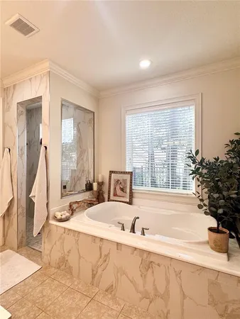 a spacious bedroom with a bed and a couch