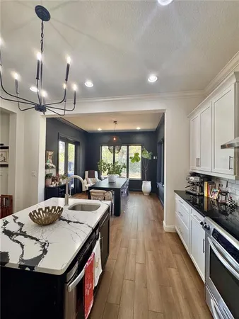a kitchen with sink stove and refrigerator