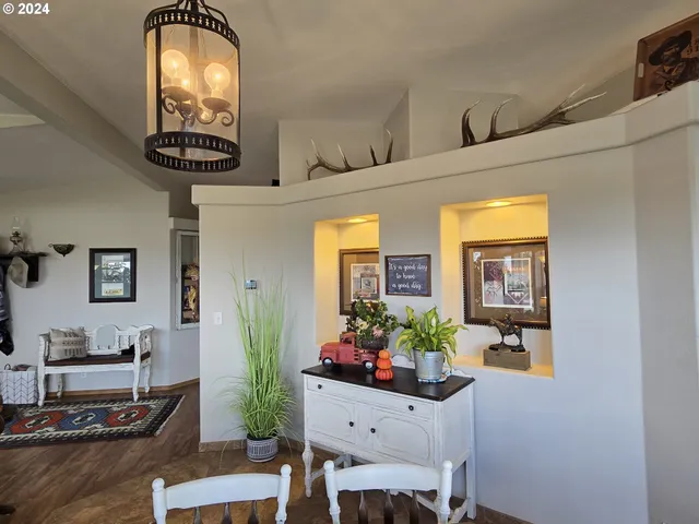 a living room with furniture a large window and a potted plant