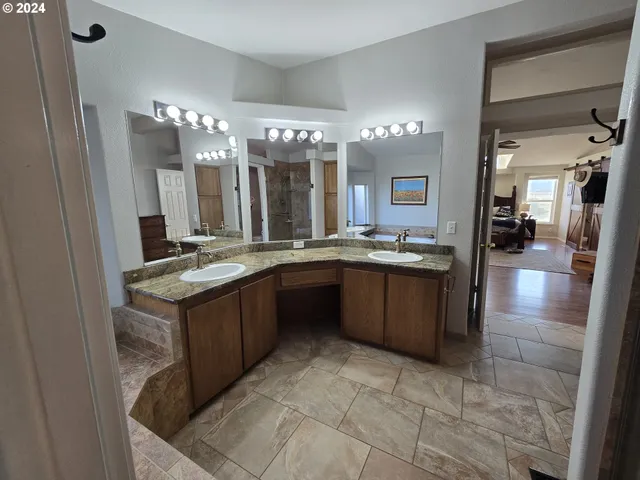 a bathroom with a shower and a sink