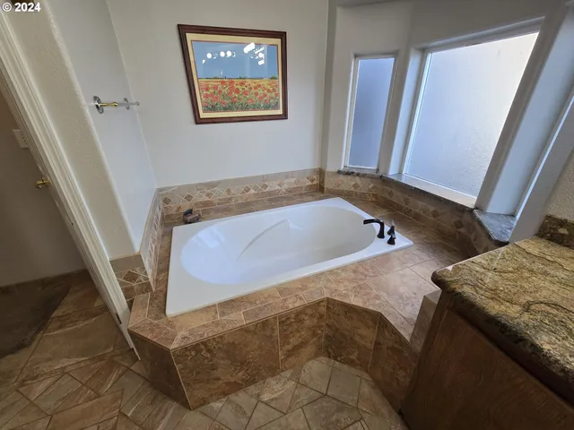 a bedroom with a bed window and a mirror