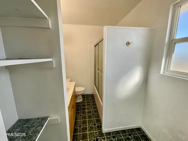a view of storage and utility room with a window