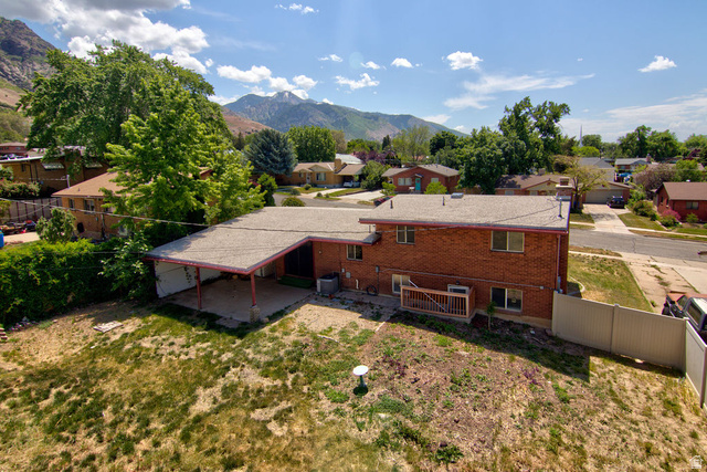 1272 Cook Street Ogden, UT 84404 - Photo 2 of 46 Red brick exterior featuring a covered patio, rear deck, and a partially fenced yard