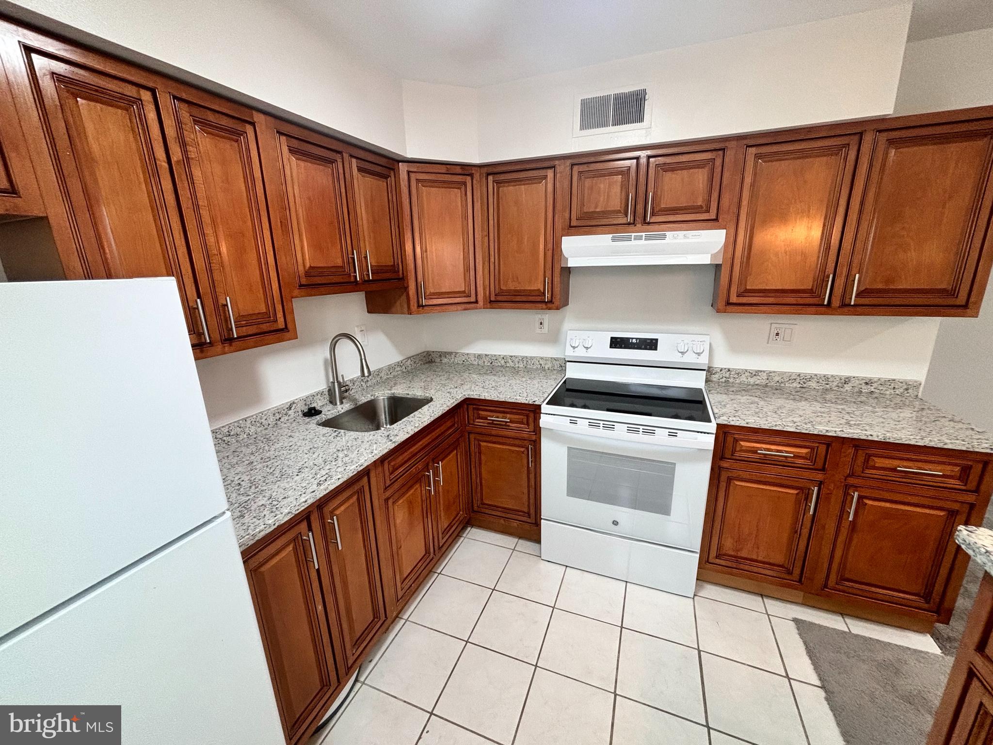 3810 V Street Southeast, Unit 301 Washington, DC 20020 - Photo 9 of 30 View of new granite countertop & white appliances