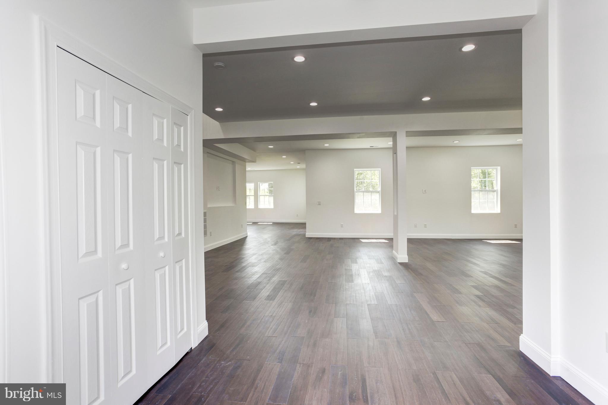 7505 June Street Springfield, VA 22150 - Photo 3 of 29 a view of an empty room with wooden floor and a window