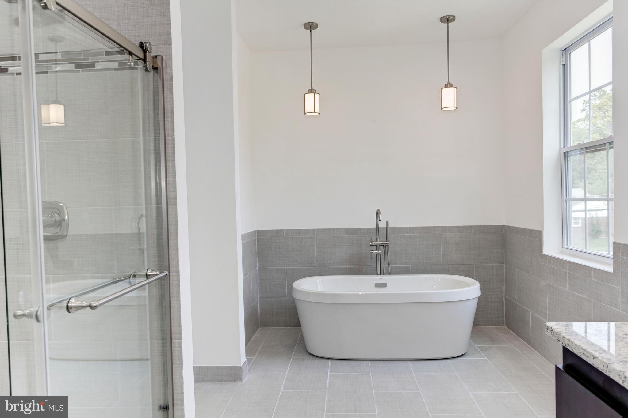 7505 June Street Springfield, VA 22150 - Photo 21 of 29 a bathroom with a bathtub and shower
