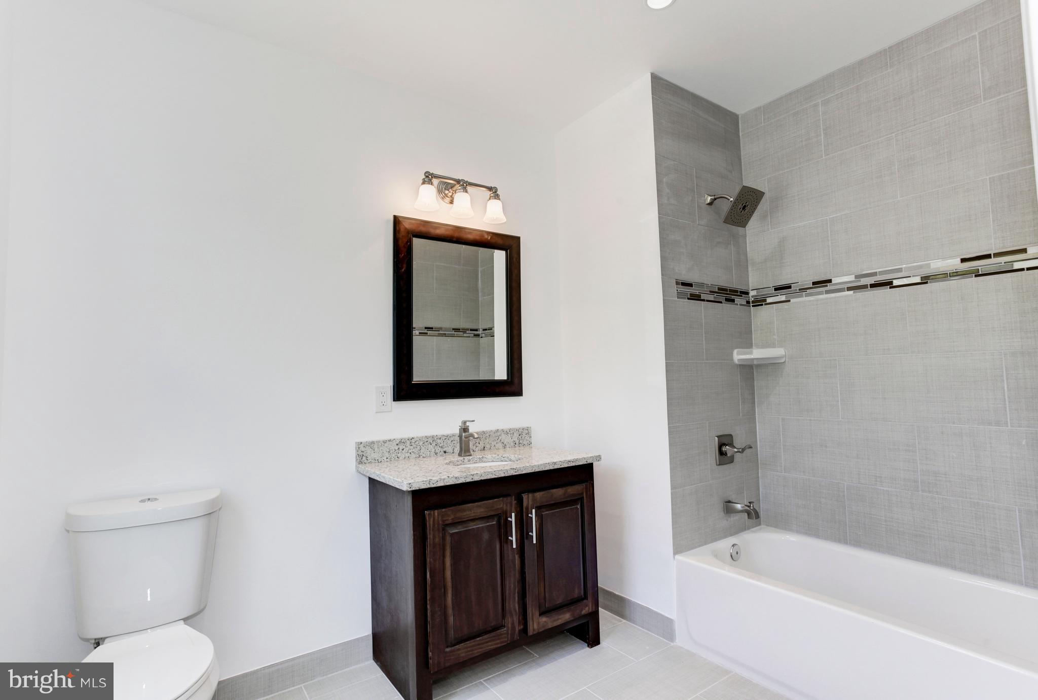 7505 June Street Springfield, VA 22150 - Photo 29 of 29 a bathroom with a toilet sink and mirror