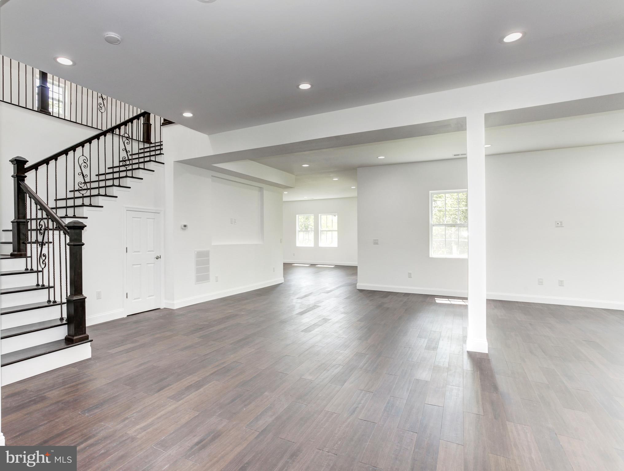 7505 June Street Springfield, VA 22150 - Photo 4 of 29 a view of an empty room with wooden floor and stairs