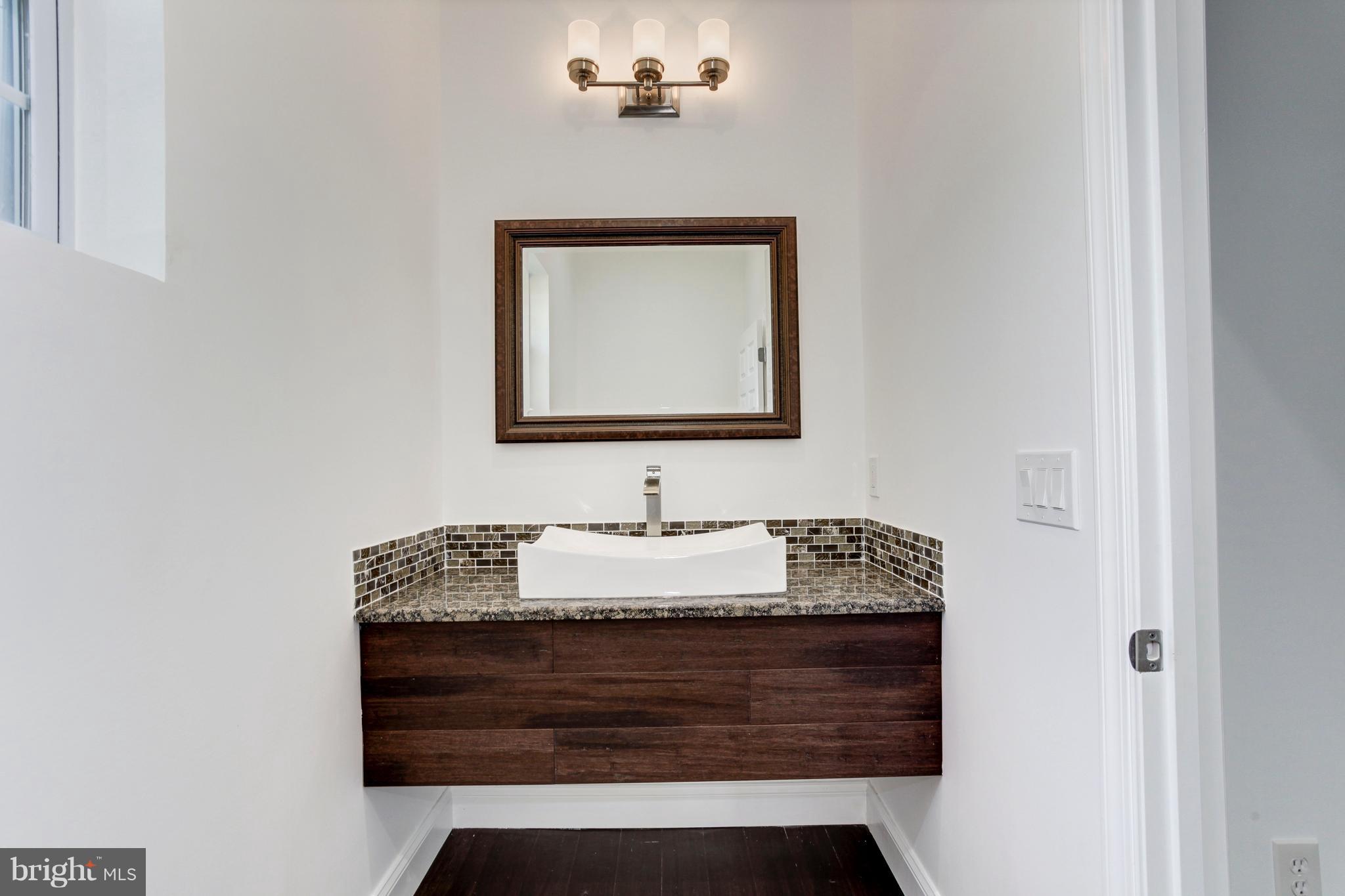 7505 June Street Springfield, VA 22150 - Photo 5 of 29 a bathroom with a sink and a mirror