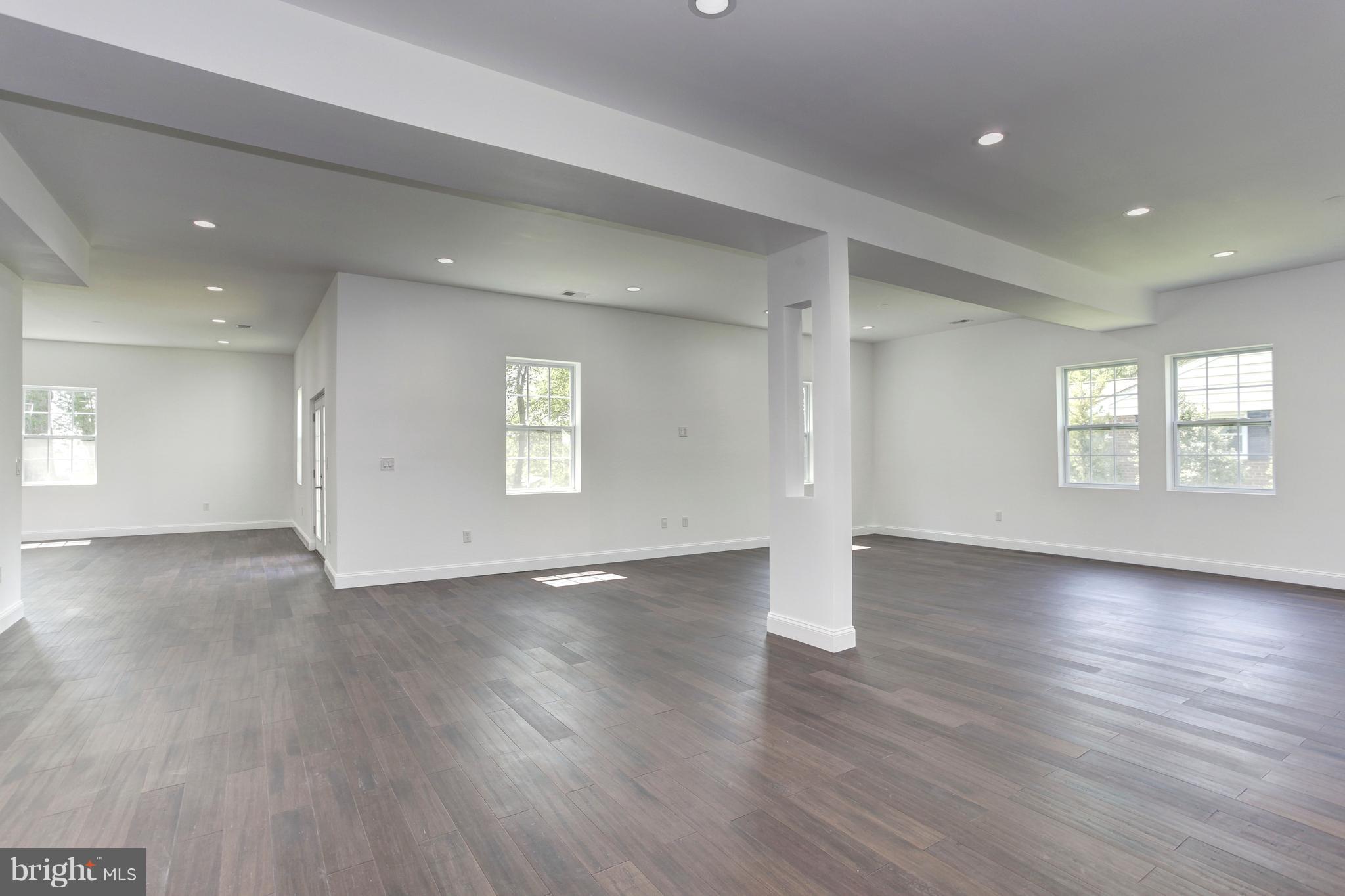 7505 June Street Springfield, VA 22150 - Photo 6 of 29 an empty room with wooden floor and windows