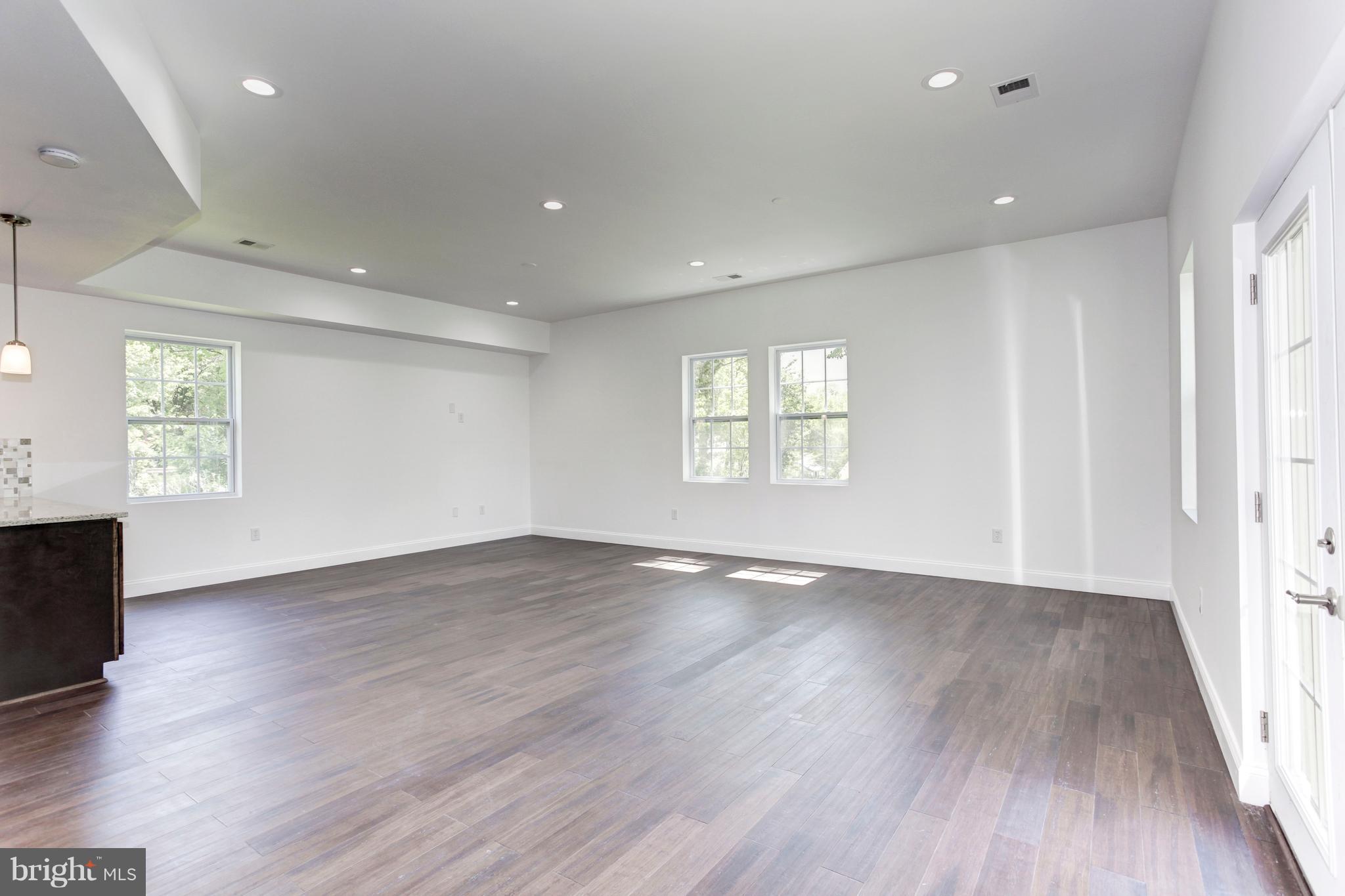 7505 June Street Springfield, VA 22150 - Photo 9 of 29 an empty room with wooden floor and windows
