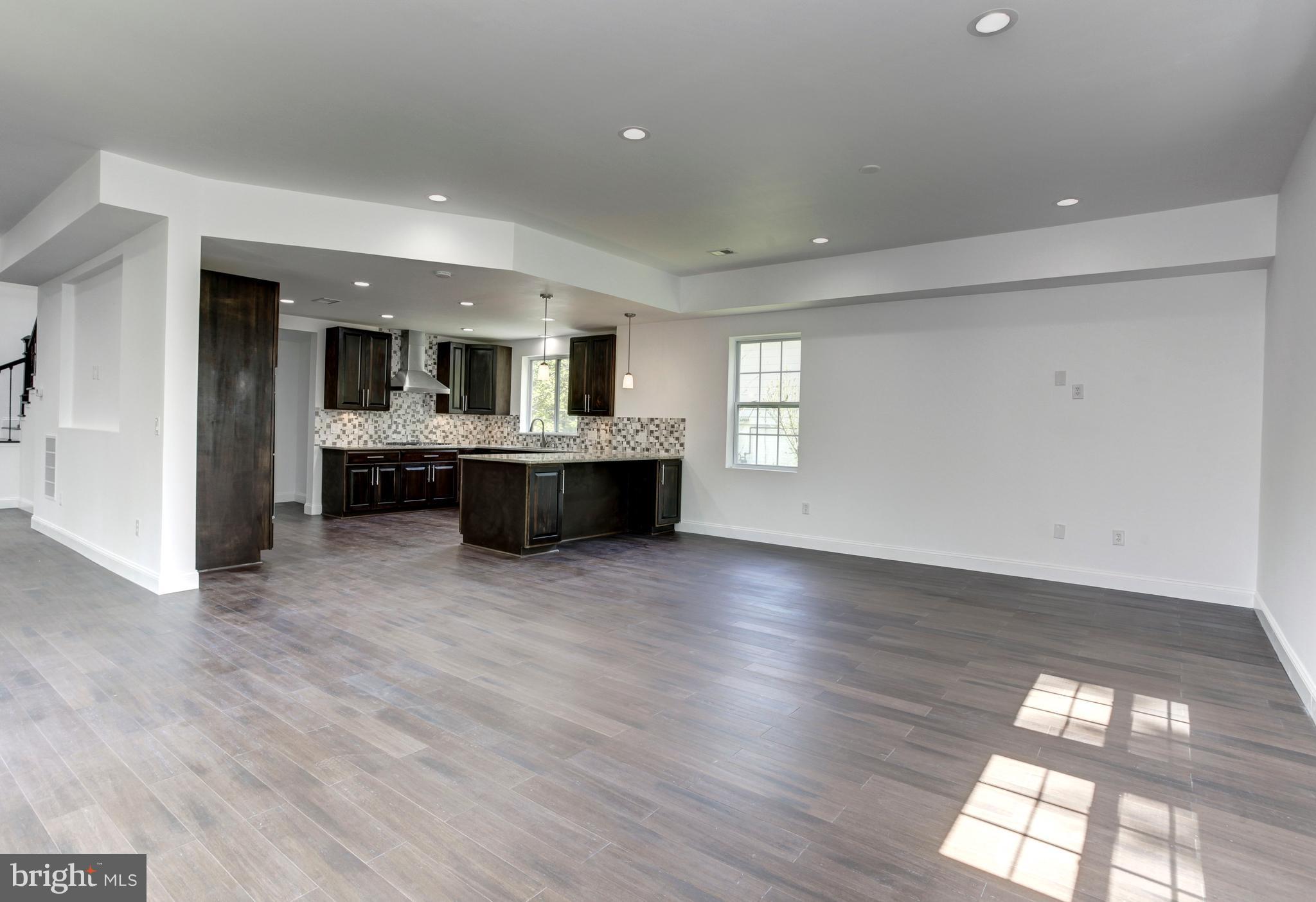 7505 June Street Springfield, VA 22150 - Photo 10 of 29 a living room with hard wood floors and kitchen view