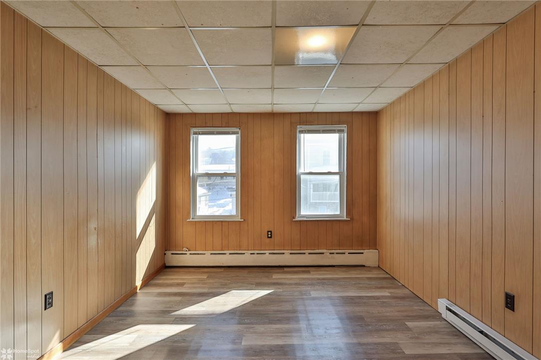 115 East Ruddle Street Coaldale, PA 18218 - Photo 27 of 57 Classic wood paneling and durable vinyl plank flooring define this versatile bonus room.