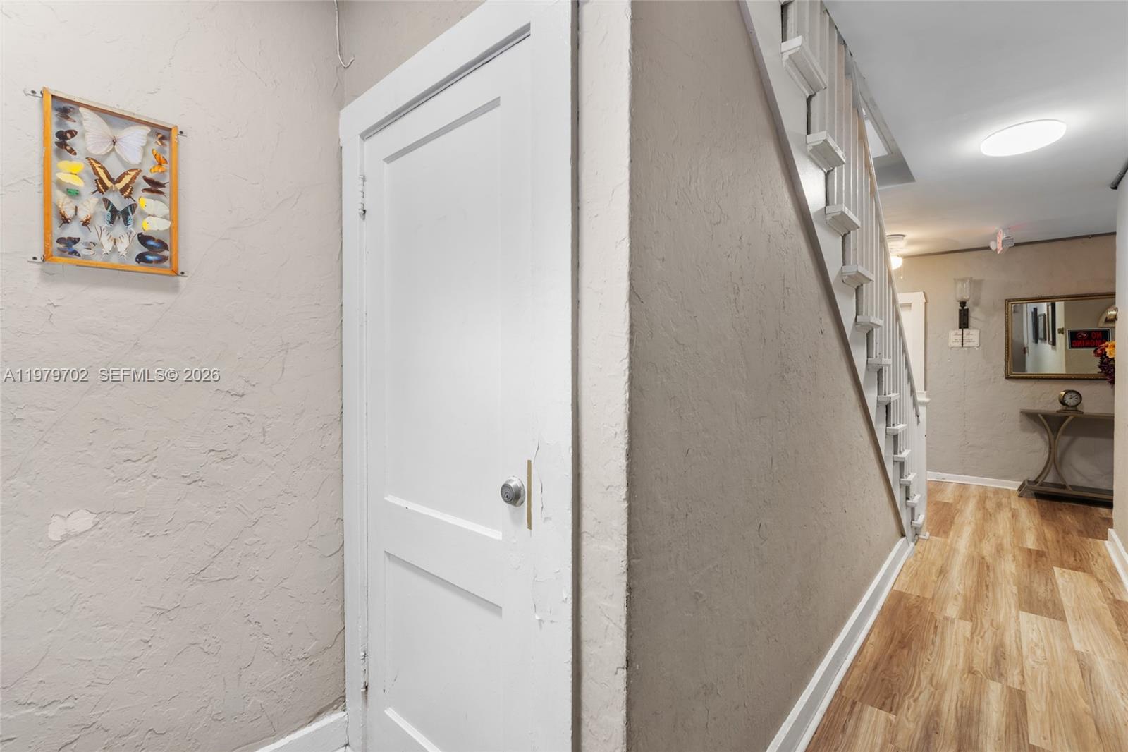 3409 South Le Jeune Road Coral Gables, FL 33134 - Photo 36 of 53 a view of a hallway with wooden floor and staircase