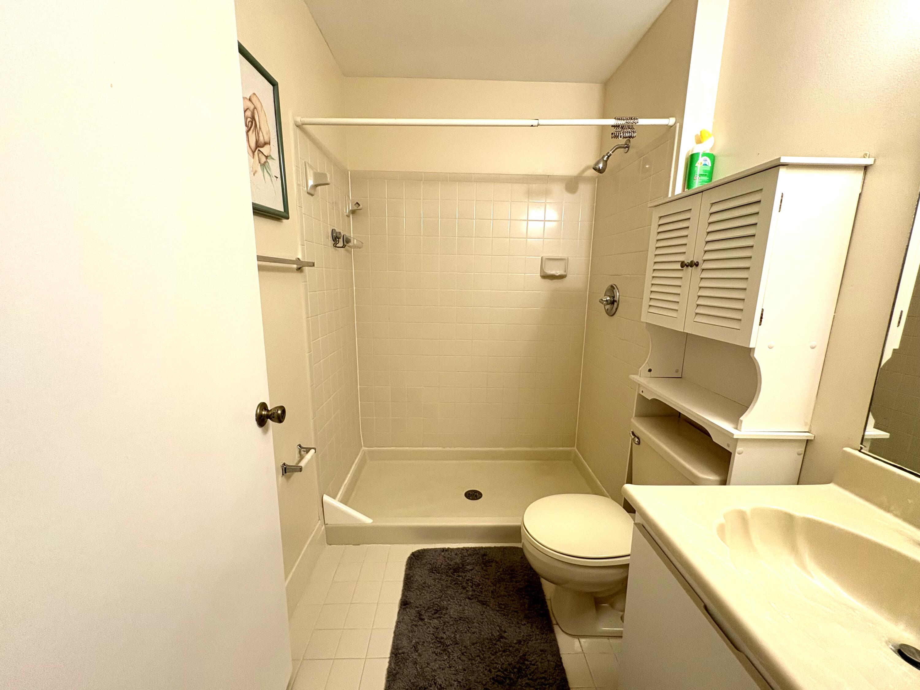 9485 Boca Cove Circle, Unit 709 Boca Raton, FL 33428 - Photo 28 of 42 a bathroom with a sink a toilet and shower