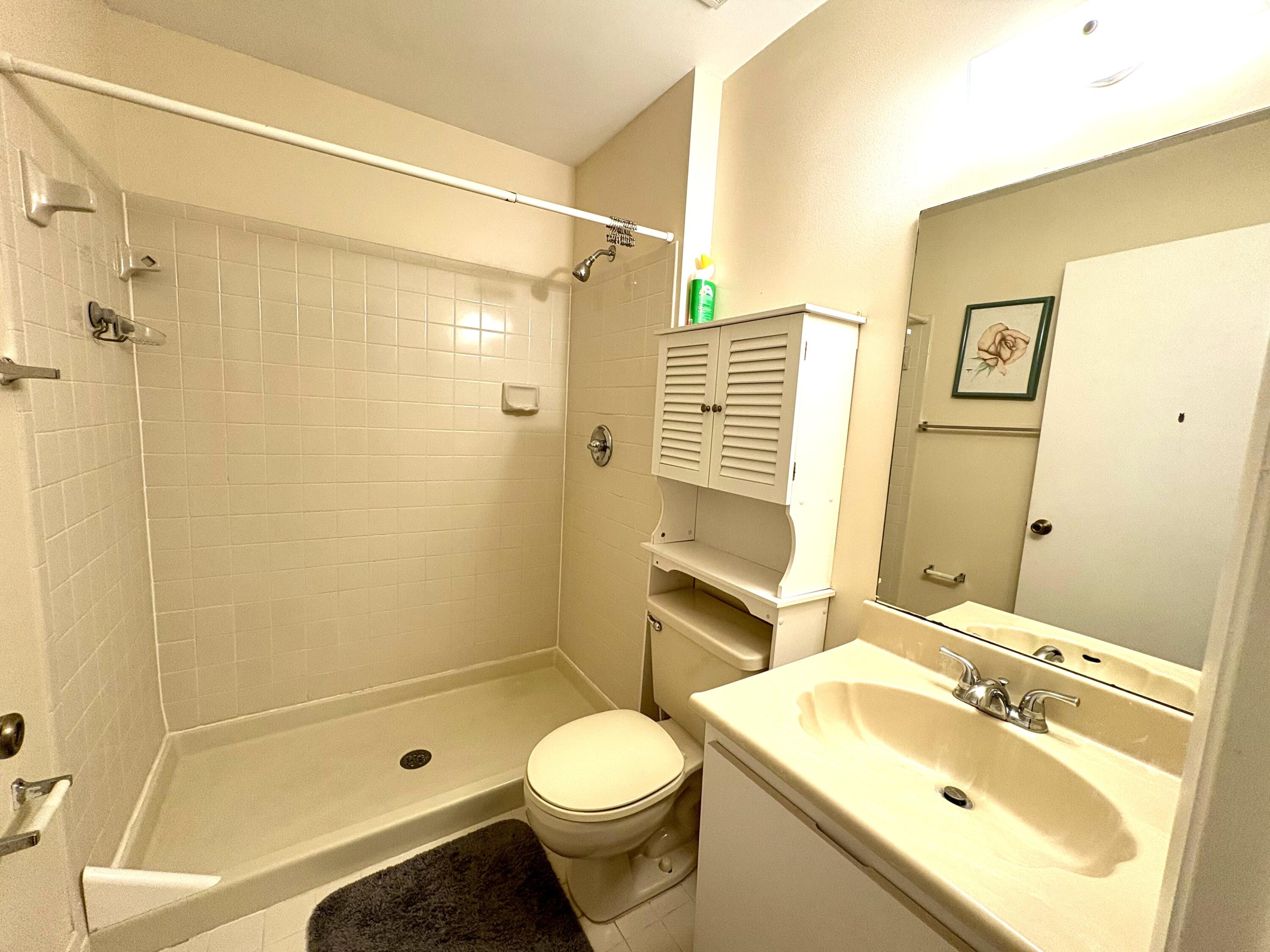 9485 Boca Cove Circle, Unit 709 Boca Raton, FL 33428 - Photo 29 of 42 a bathroom with a sink toilet and shower