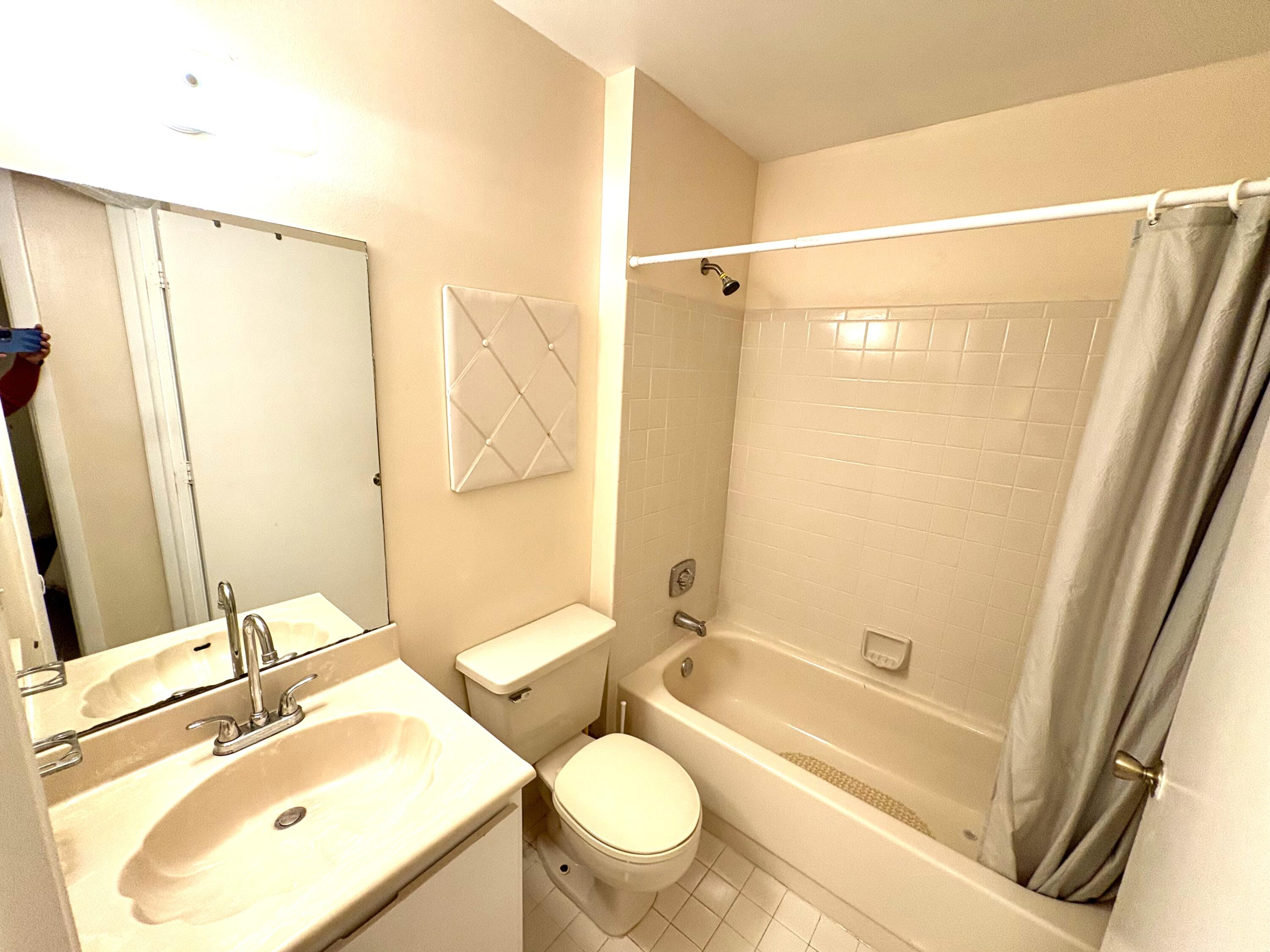 9485 Boca Cove Circle, Unit 709 Boca Raton, FL 33428 - Photo 33 of 42 a bathroom with a sink toilet and shower