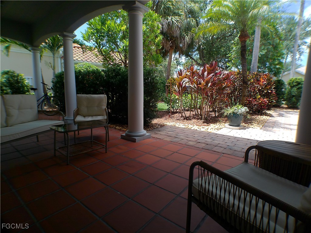 4780 Martinique Way Naples, FL 34119 - Photo 13 of 49 a view of backyard with patio and outdoor seating