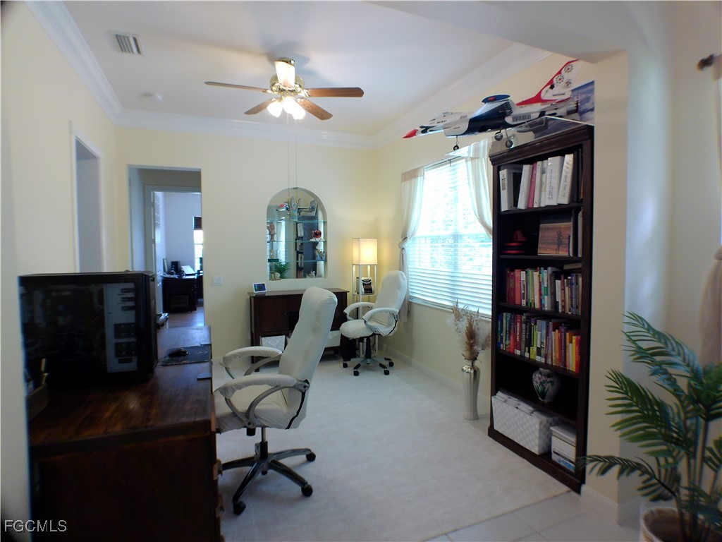 4780 Martinique Way Naples, FL 34119 - Photo 16 of 49 a view of a workspace with furniture and a bookshelf