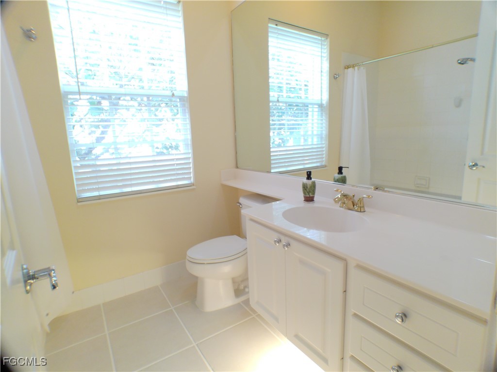 4780 Martinique Way Naples, FL 34119 - Photo 18 of 49 a bathroom with a sink toilet and vanity
