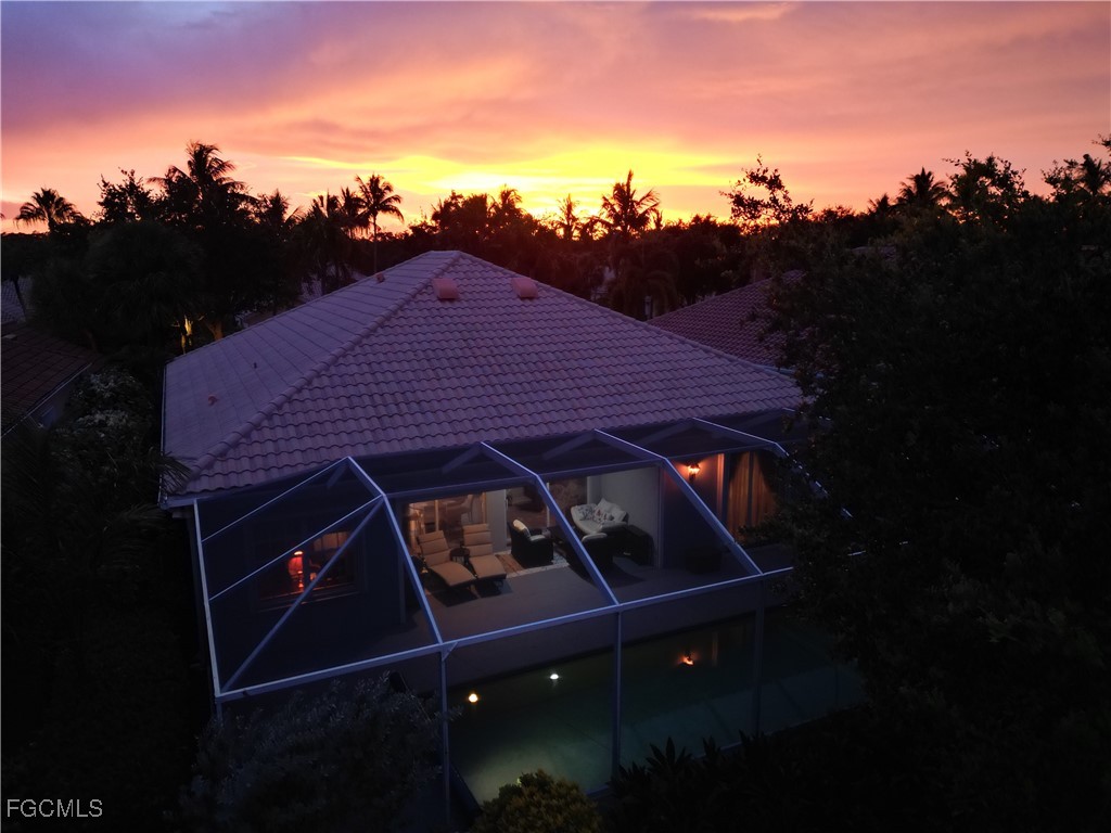 4780 Martinique Way Naples, FL 34119 - Photo 2 of 49 a view of a roof deck with table and chairs